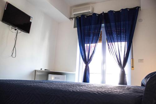 a bedroom with a bed and a window at Bed end Breakfast Mediterraneo in Scalea