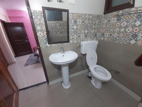 a bathroom with a toilet and a sink at Shimla Pines Homestay in Shimla