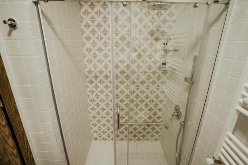 a shower with a glass door in a bathroom at West Apart Hotel in Batumi