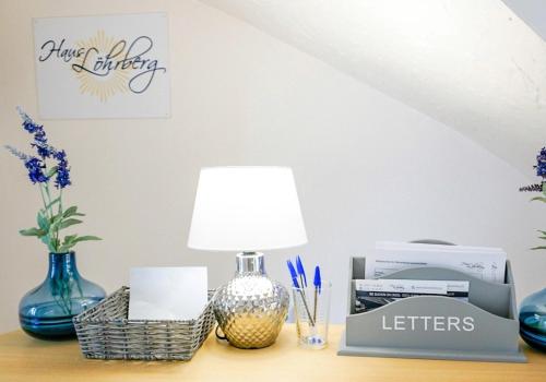 a table with a lamp and other items on it at Haus Löhrberg in Hemer