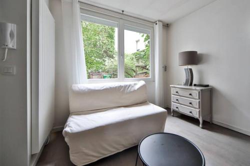 sala de estar con silla y ventana en Studio 4P Calme/Full Equipped/Charonne/PereLachese, en París