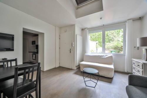 a living room with a couch and a table at Studio 4P Calme/Full Equipped/Charonne/PereLachese in Paris
