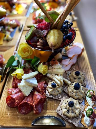 a table with a bunch of different types of food at Hotel Coandi in Arad