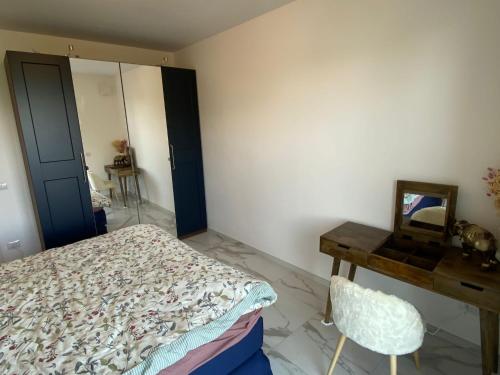 a bedroom with a bed and a desk and a mirror at Amadeus in Baveno