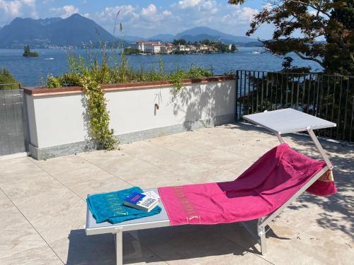 a table and a chair with a book on it at Amadeus in Baveno