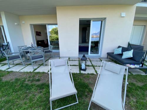 two folding chairs sitting in the grass in a yard at Amadeus in Baveno