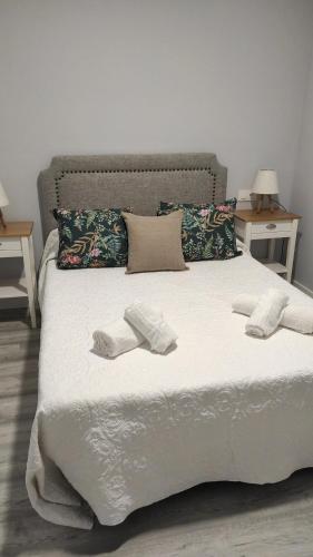 a bed with two towels and two pillows on it at LOFT CON ENCANTO in Arcos de la Frontera