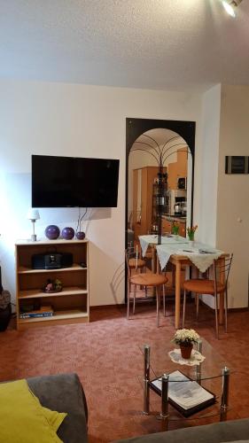 a living room with a table and a dining room at Apartment Blütenstadt Werder im Souterraine in Werder