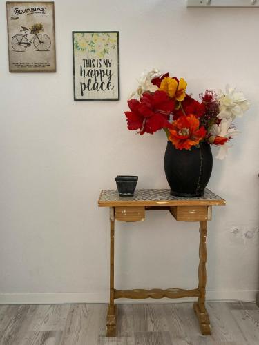a vase filled with flowers sitting on a table at Countryside in Füle