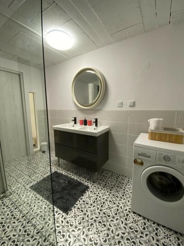 a bathroom with a washing machine and a sink at Countryside in Füle