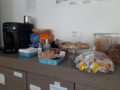 a counter with some food and snacks on it at Ostello Bella Calabria in Torre Ritani