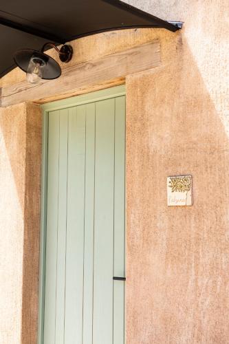 a door to a building with a sign on it at ECOTurisme Can Buch HOTEL in Sant Aniol de Finestras