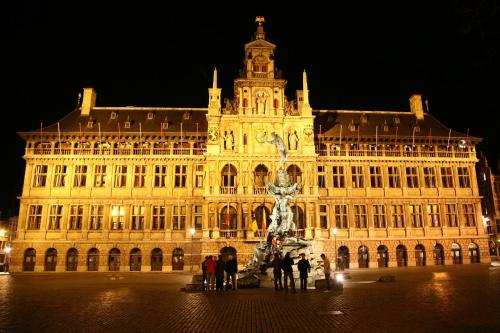 a large building with a statue in front of it at Trip Inn Eden Antwerpen in Antwerp