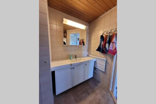 a bathroom with a sink and a mirror at Golfapartment in Pickala in Sjundeå