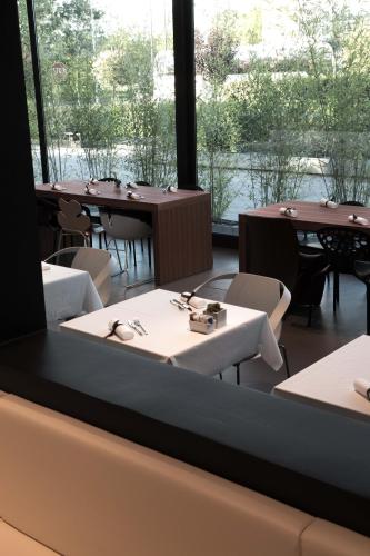 a restaurant with tables and chairs and a large window at Point Hotel in Piove di Sacco