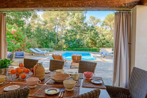 une table avec de la nourriture dessus à côté d'une piscine dans l'établissement Le Clos de Bagalance, à Barbentane