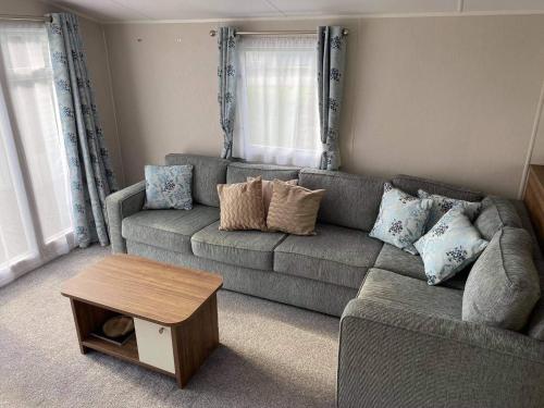 a living room with a couch and a coffee table at Kellys Holiday Homes 24 Willerby 2 bedrooms caravan in Weeley