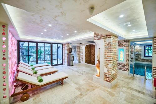 a living room with a pool and a brick wall at Stara Čaršija Hotel & SPA in Bar