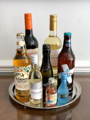 a tray filled with different types of bottles of alcohol at The Claremont Hotel-Adult Only in Polperro