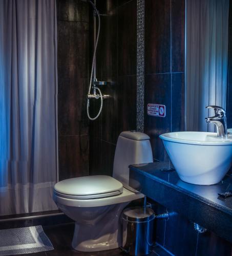 a bathroom with a toilet and a sink at Abbacy Katiana's Castelleti 1 in Limenas