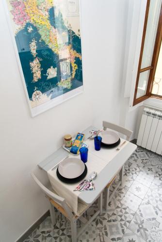 a white table with two plates on top of it at La Candida Rosa in Florence