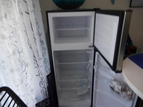 an empty refrigerator with its door open in a kitchen at THE BLUE ROOM Luxury suite in Dover