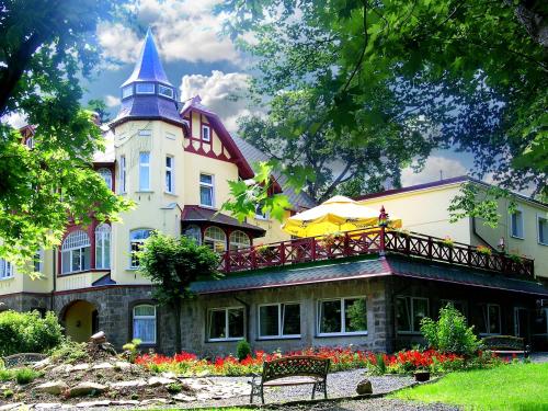 a large house with a tower on top of it at Kaja Medical & Spa in Świeradów-Zdrój