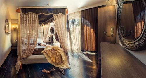 a bedroom with a canopy bed with curtains at Abbacy Katiana's Castelleti 1 in Limenas