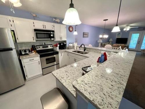 a kitchen with white counter tops and appliances at Colony III 203 Condo in Myrtle Beach