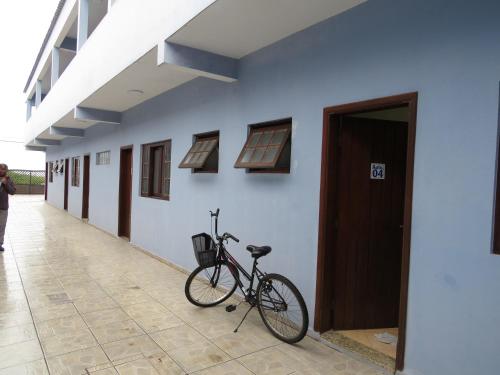 a bike parked on the side of a building at APEVO ILHA in Ilha Comprida