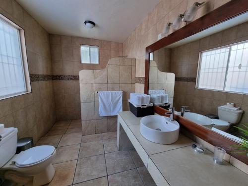 a large bathroom with two sinks and a toilet at Real de Corralejo in San Miguel de Allende