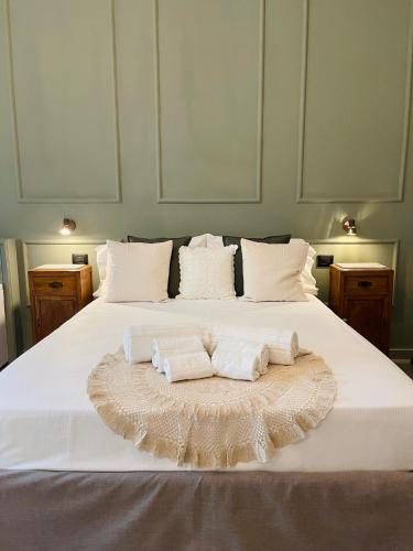 a bedroom with a bed with two towels on it at Dimora Terranova Charming Rooms in Noto