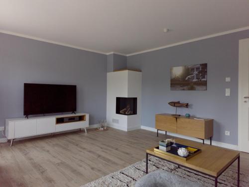 a living room with a flat screen tv on a wall at Jolle 54 in Putbus