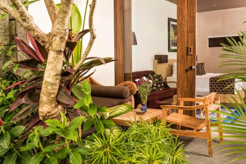 a living room filled with lots of plants at Kejora Suites in Sanur
