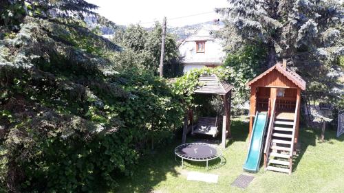 a gazebo and a playground in a yard at У Тарнавских in Mykulychyn