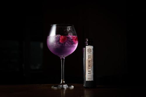 a glass of purple wine next to a bottle at Nira Alpina in Silvaplana