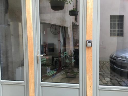 a glass door with a reflection of a room at La Grange in Avallon
