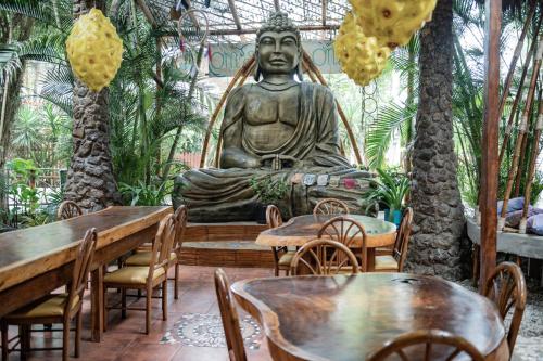 a large statue of a buddha in a restaurant at Casa del Sol in Montañita