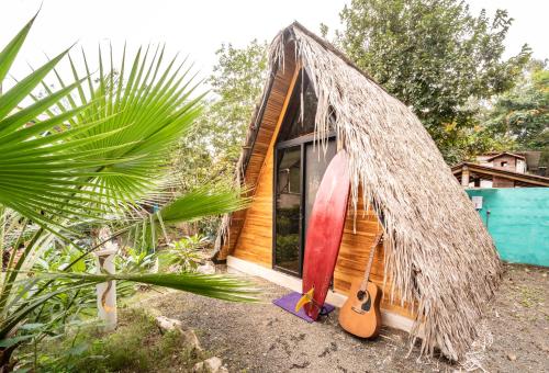 a small house with a surfboard leaning against it at Casa del Sol in Montañita