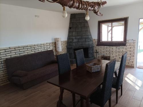 sala de estar con mesa, sofá y chimenea en Casa Noa, en Huesca