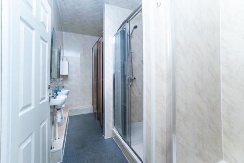 a bathroom with a shower and a sink at The New Mill Apartments in Newcastle upon Tyne