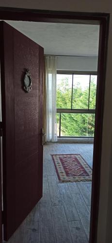 an open door to a room with a large window at Gölyaka Hotel in Bursa
