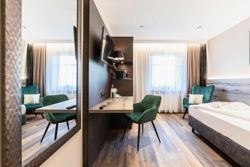 Ένα ή περισσότερα κρεβάτια σε δωμάτιο στο Hotel Demas München-Unterhaching