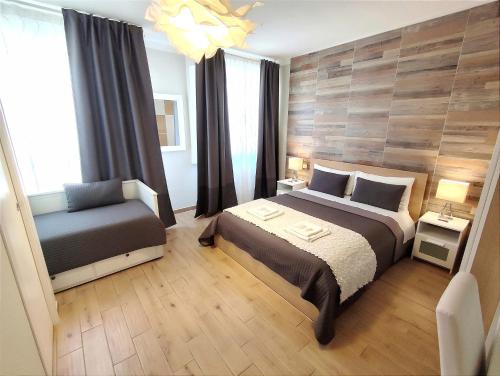 a bedroom with a large bed and a chair at Pisa City Lodge in Pisa