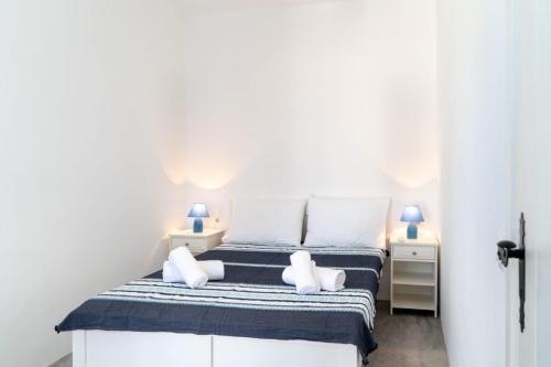 a bedroom with a bed with two pillows at Blue Moon Apartments in Makry Gialos