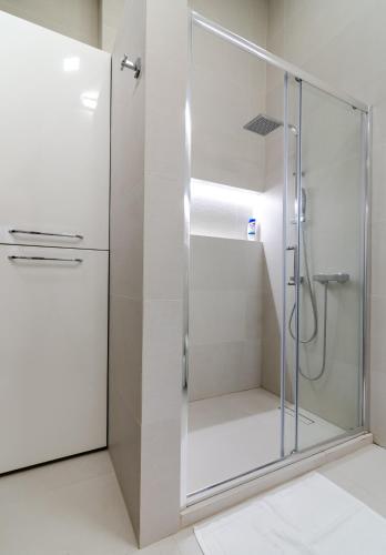 a shower with a glass door in a bathroom at 7 Senses Luxury Apartment in Gudauri