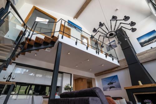 a living room with a spiral staircase in a house at 7 Senses Luxury Apartment in Gudauri