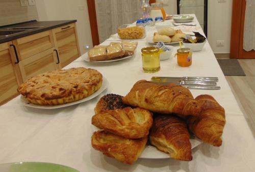 a table with croissants and other pastries on at La stazione in Monselice