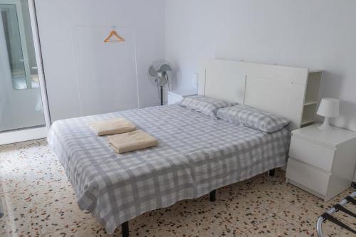 a bedroom with a bed with two towels on it at Teniente Ruiz 27 in Elche