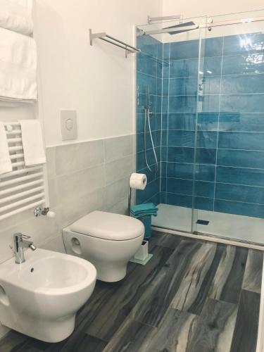 a bathroom with a toilet and a glass shower at Calida B&B in Castellammare del Golfo